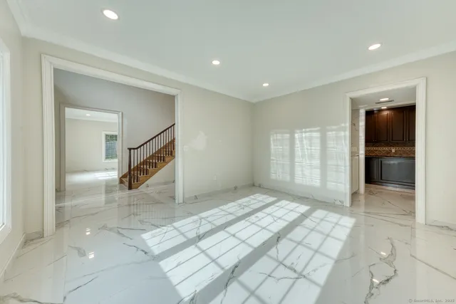 a view of an empty room and a bathroom