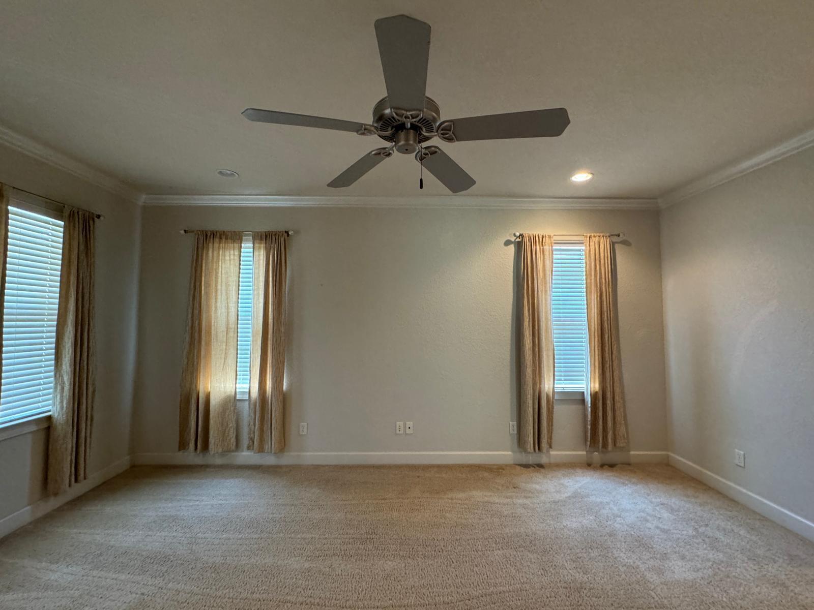 241 Inverrary Drive Destin, FL 32541 - Photo 10 of 24 an empty room with chandelier fan and windows