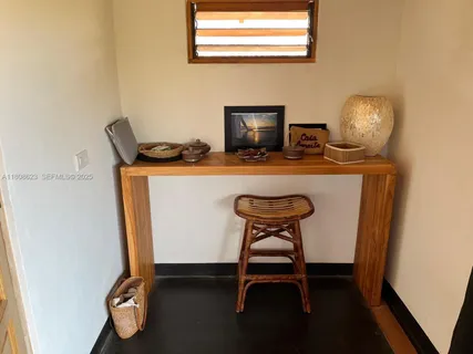 a view of a living room and floor to ceiling window with wooden floor
