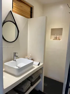 a room with wooden floor and outdoor seating