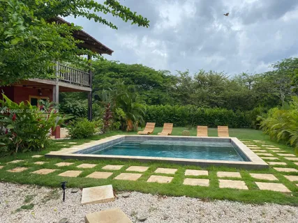 a view of a swimming pool with a yard