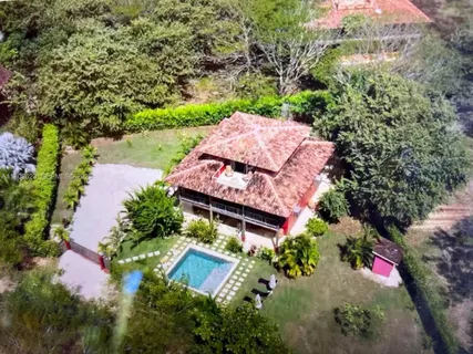 a bedroom with a bed a dresser and a window