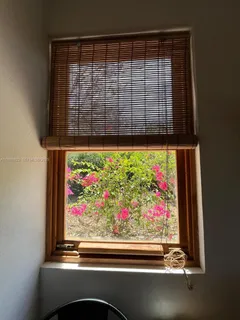 a view of a livingroom with furniture wooden floor and windows