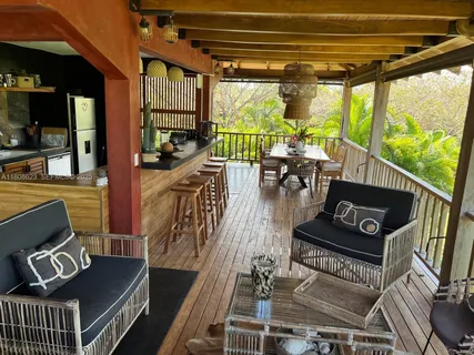 a living room with furniture fireplace and a large window