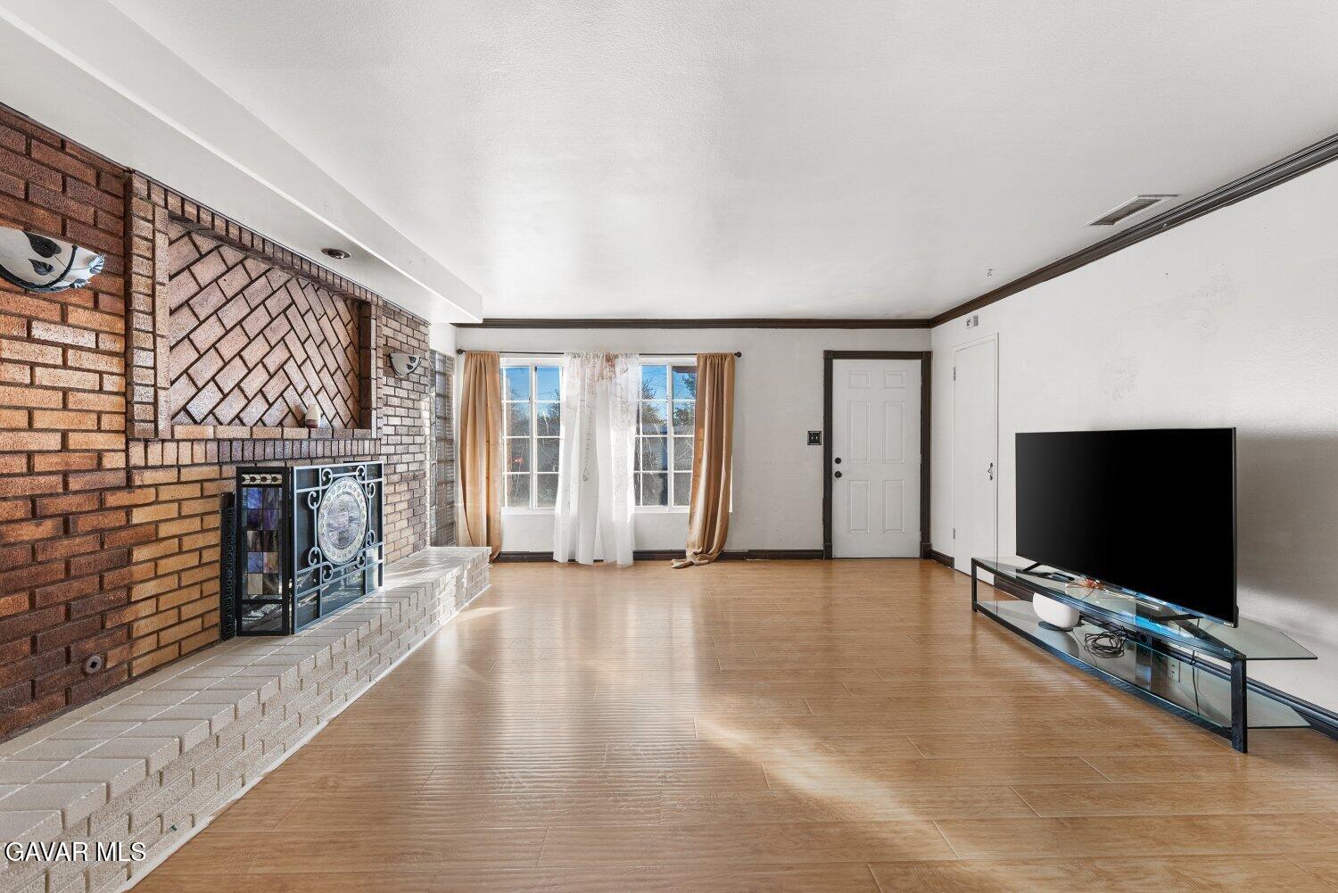 44221 4th Street East Lancaster, CA 93535 - Photo 3 of 68 a living room with fireplace furniture and a flat screen tv