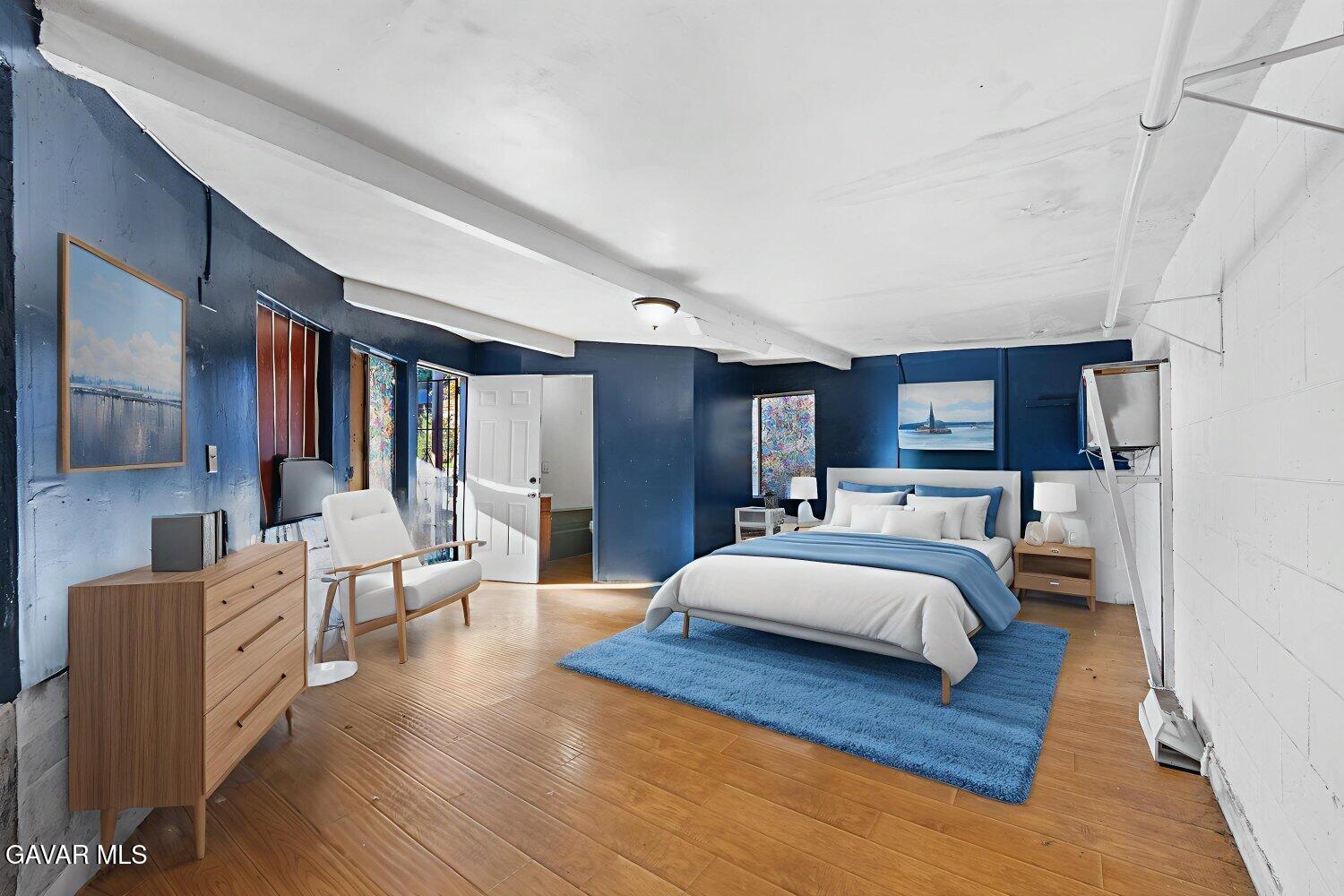 44221 4th Street East Lancaster, CA 93535 - Photo 45 of 68 a large bedroom with wooden floor and furniture