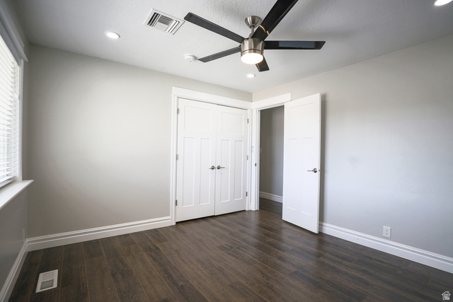 422 West Buckeye Reef Road Leeds, UT 84746 - Photo 36 of 47 Unfurnished bedroom with dark wood-style floors, a ceiling fan, a closet, and recessed lighting