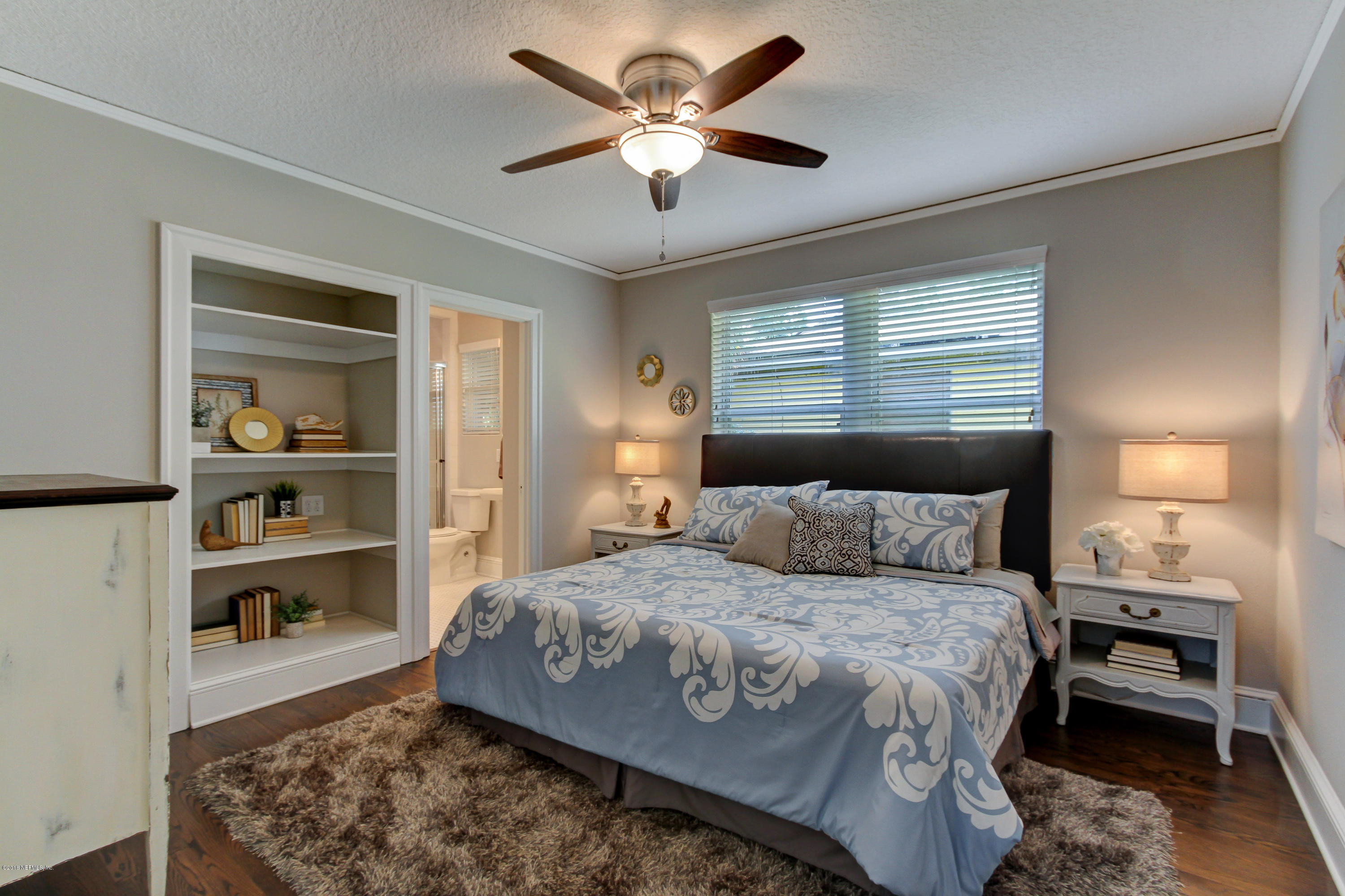 1026 Riviera Street Jacksonville, FL 32207 - Photo 11 of 48 a bedroom with a large bed and a chandelier