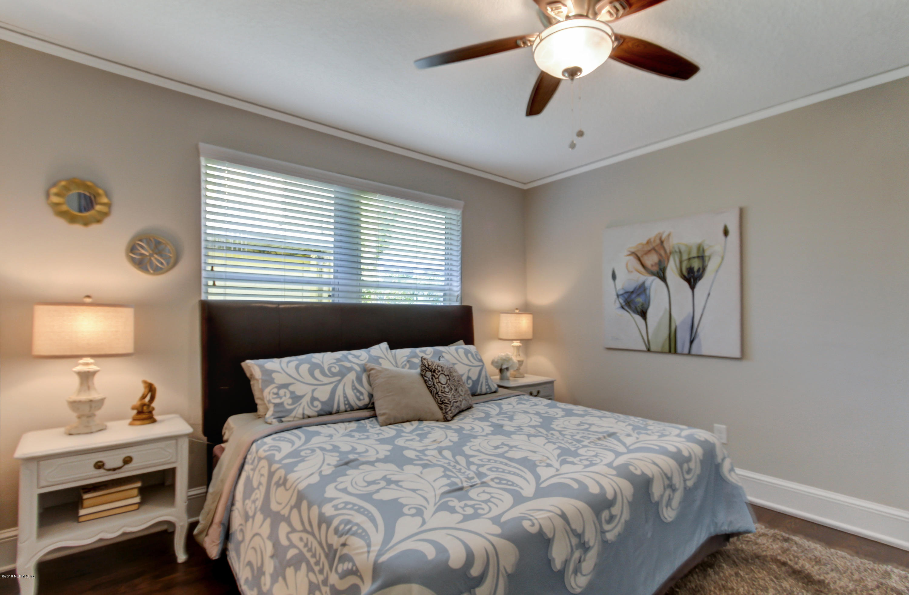 1026 Riviera Street Jacksonville, FL 32207 - Photo 12 of 48 a bedroom with a bed and a chandelier