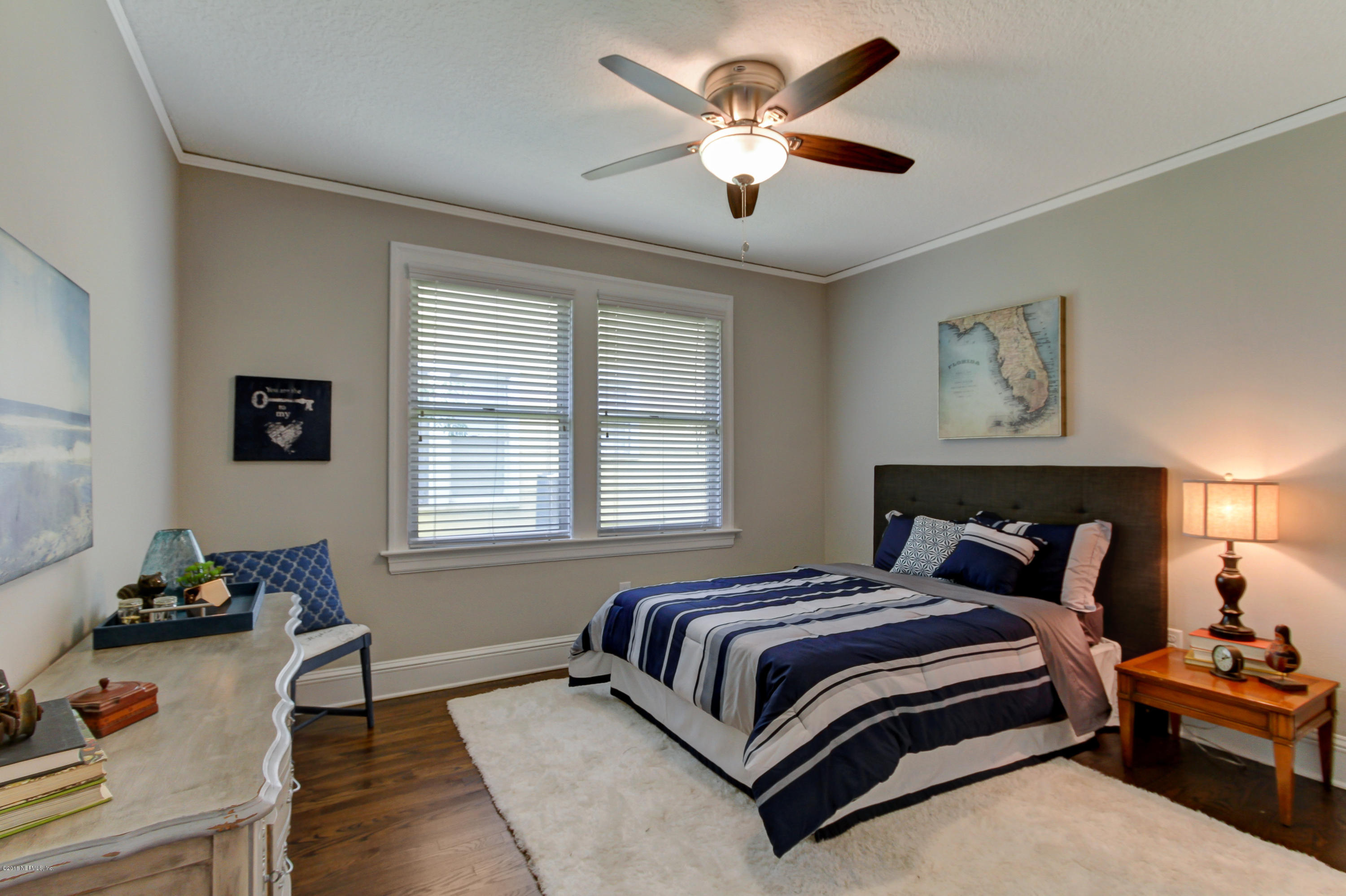 1026 Riviera Street Jacksonville, FL 32207 - Photo 15 of 48 a bedroom with a bed and a chandelier