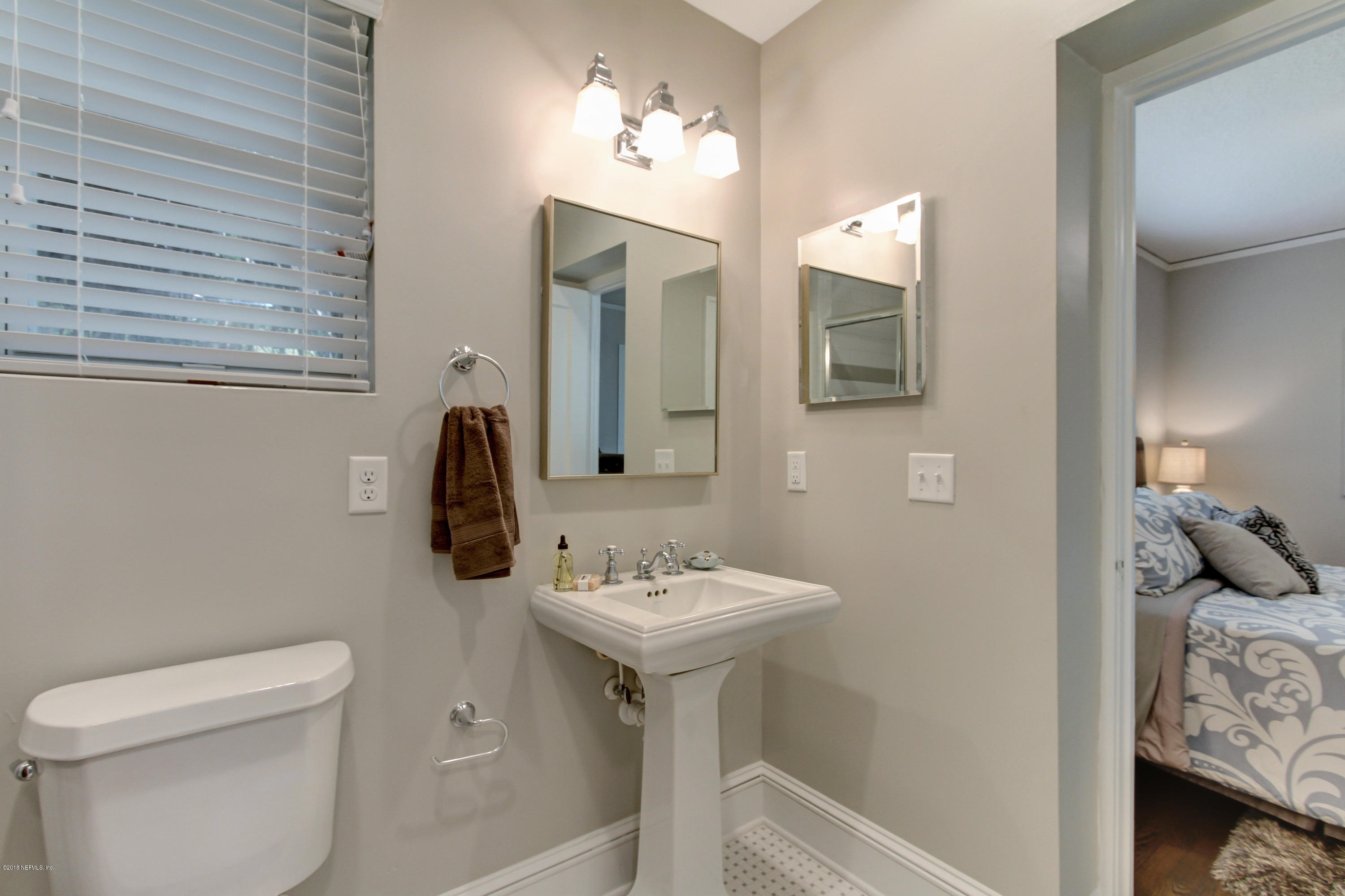 1026 Riviera Street Jacksonville, FL 32207 - Photo 19 of 48 a bathroom with a sink toilet and mirror