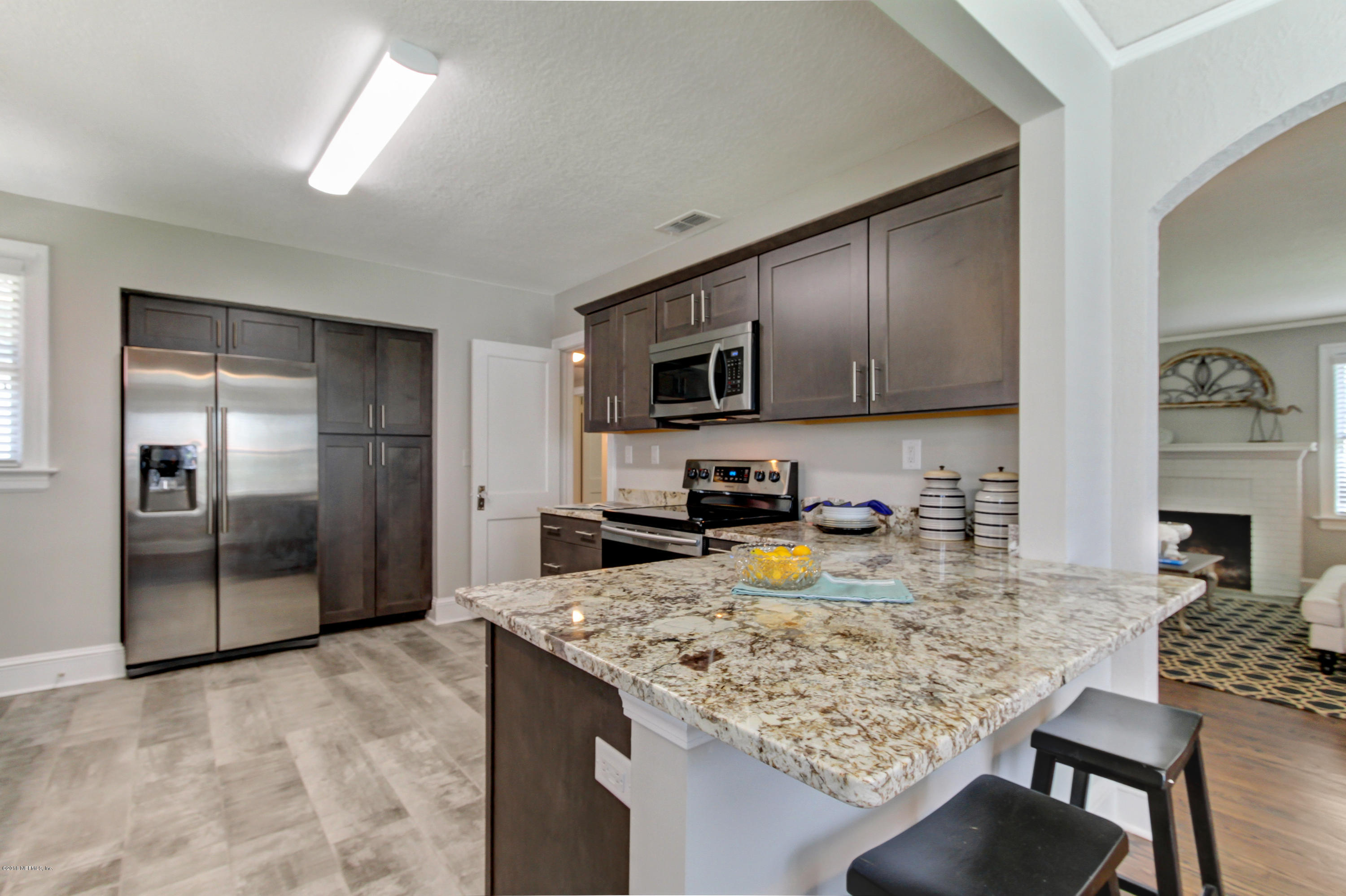 1026 Riviera Street Jacksonville, FL 32207 - Photo 23 of 48 a kitchen with refrigerator and cabinets