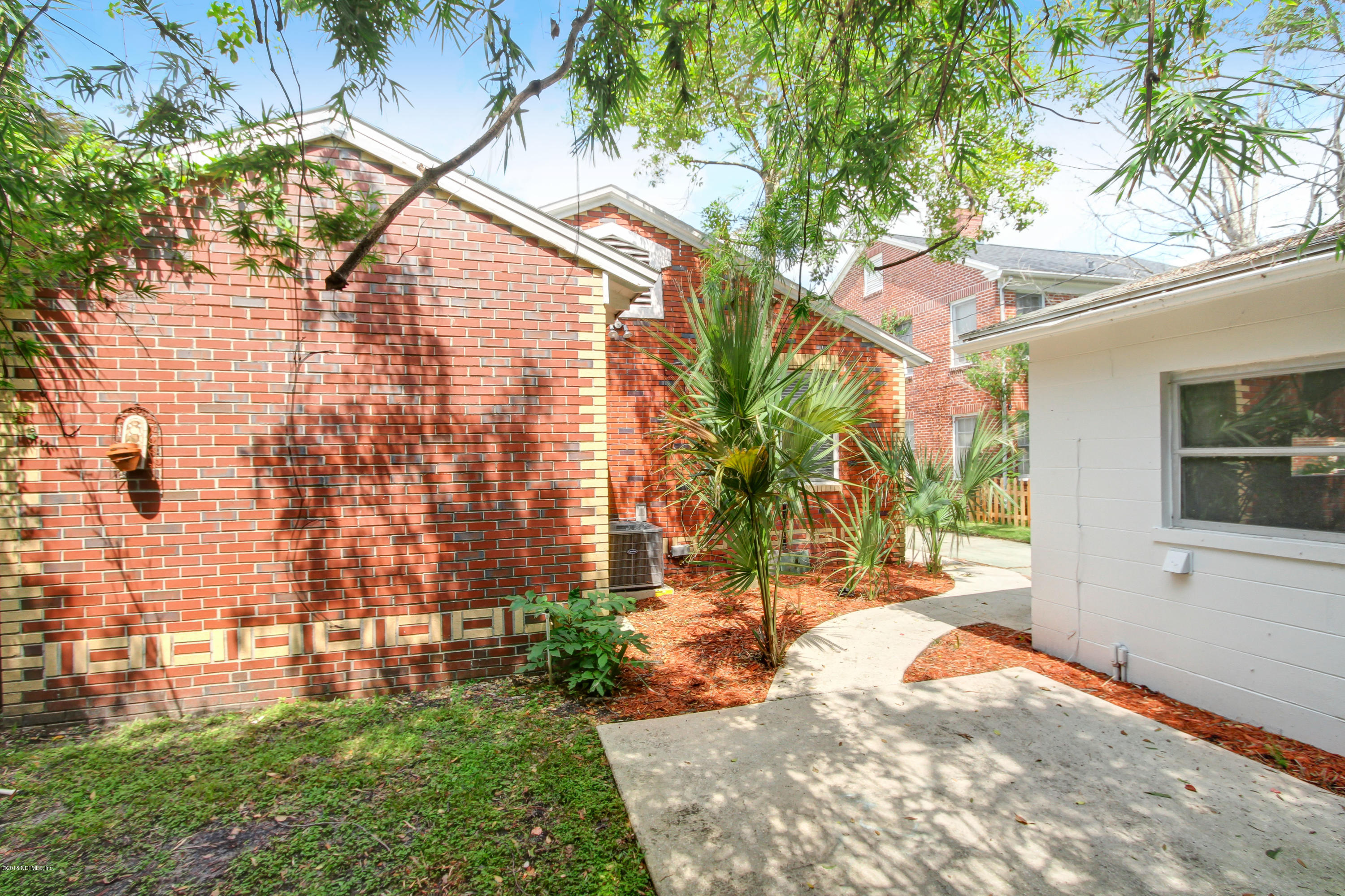 1026 Riviera Street Jacksonville, FL 32207 - Photo 33 of 48 a view of backyard with plants and outdoor seating