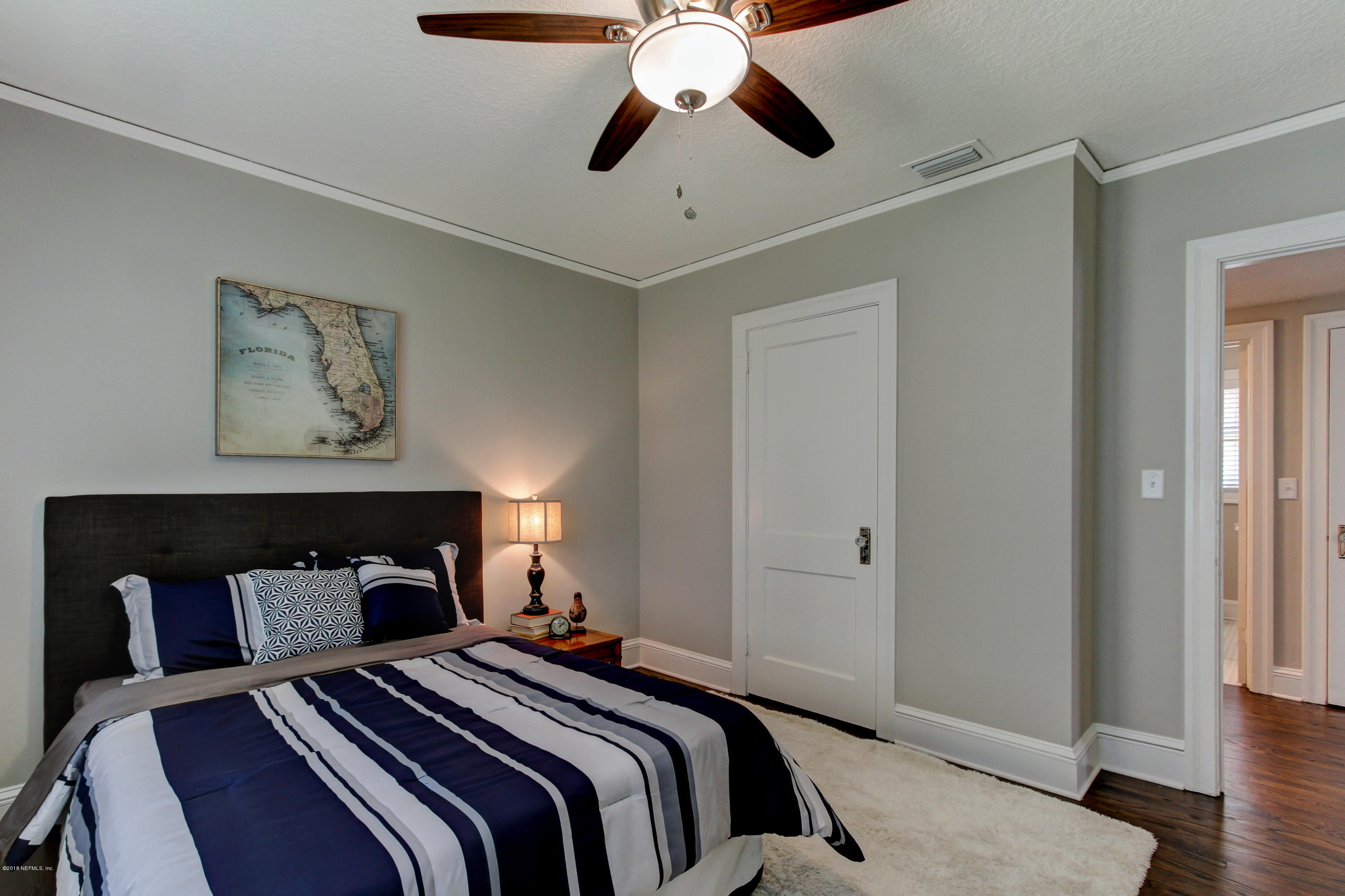 1026 Riviera Street Jacksonville, FL 32207 - Photo 37 of 48 a bedroom with a bed and a chandelier