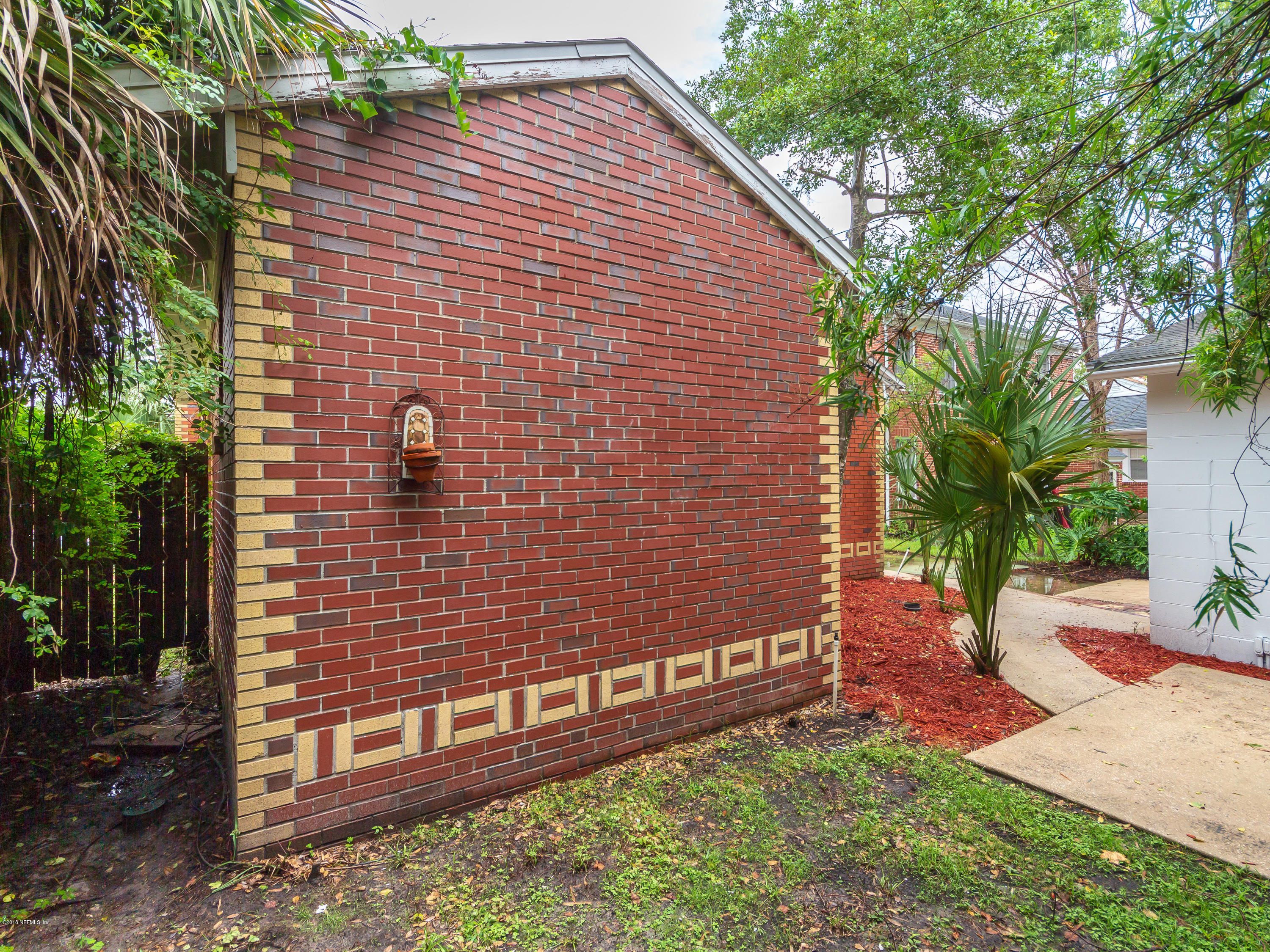 1026 Riviera Street Jacksonville, FL 32207 - Photo 38 of 48 a brick building with a small yard
