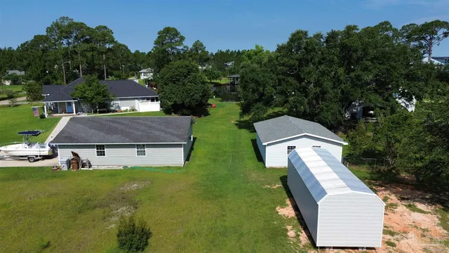 a aerial view of a house with garden space and street view