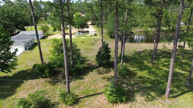 an aerial view of a house with a yard