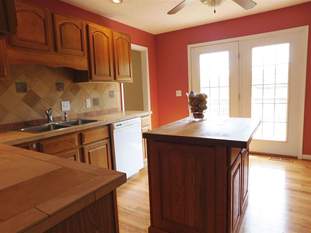 154 Raintree Road Verona, VA 24482 - Photo 14 of 49 a kitchen with kitchen island granite countertop a sink cabinets and wooden floor