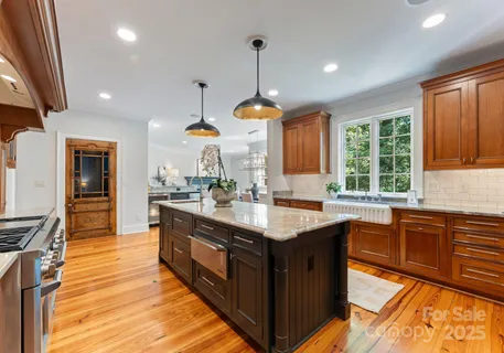 a kitchen with granite countertop a sink appliances and cabinets