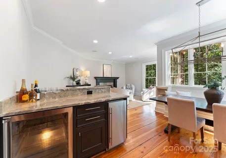 a dining room with wooden floor a chandelier