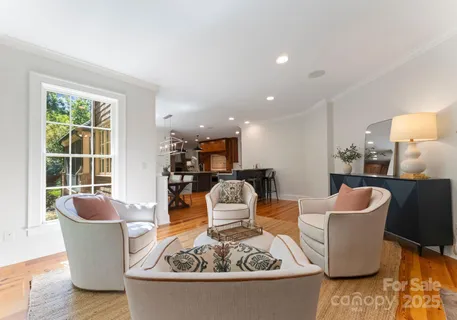 a living room with furniture a fireplace and a large window