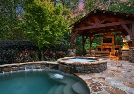 a view of a patio with table and chairs potted plants with floor to ceiling window