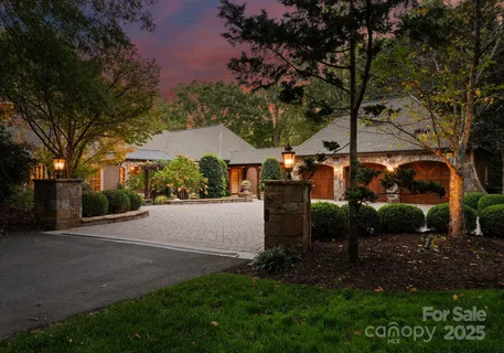an aerial view of a house with a yard and tree s