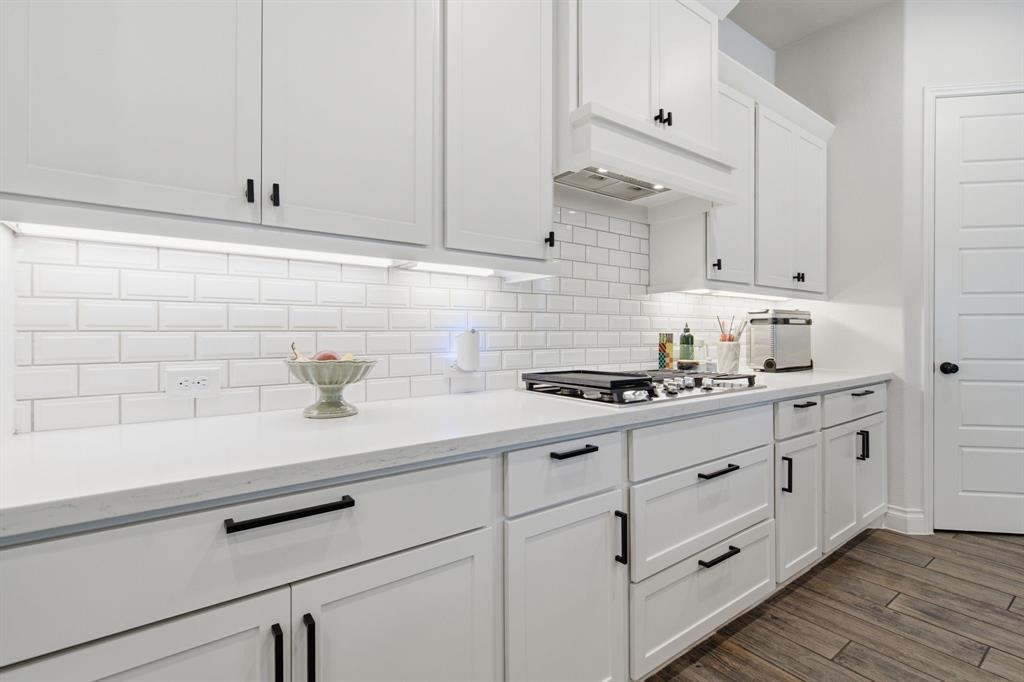 904 Fallbrook Avenue Denton, TX 76210 - Photo 8 of 30 a kitchen with granite countertop white cabinets and white appliances
