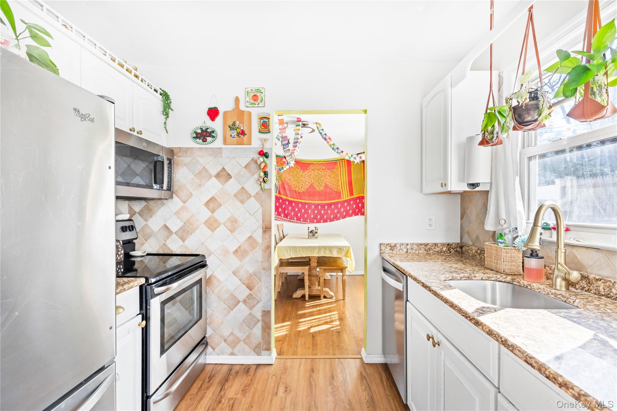 193 Maple Road Wading River, NY 11792 - Photo 9 of 17 a kitchen with stainless steel appliances granite countertop a stove a sink and a microwave