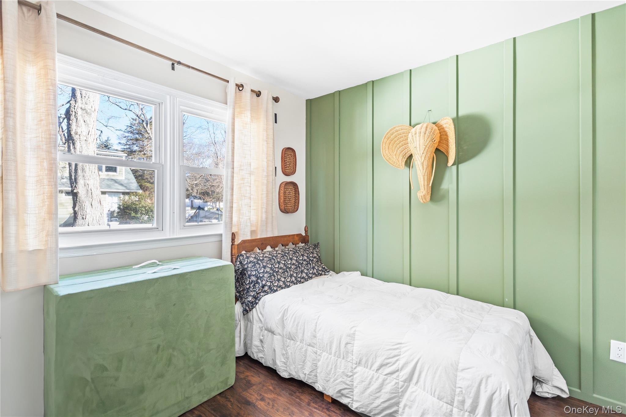 193 Maple Road Wading River, NY 11792 - Photo 10 of 17 a bedroom with a bed and a window