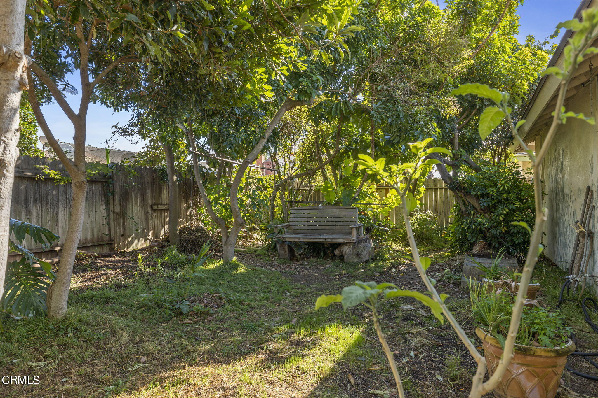 2072 Olga Street Oxnard, CA 93036 - Photo 14 of 18 a backyard of a house with lots of green space and fountain
