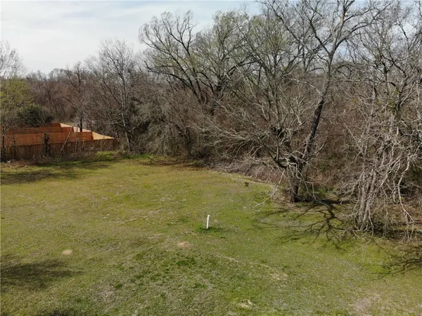 a aerial view of residential house with pool and trees all around