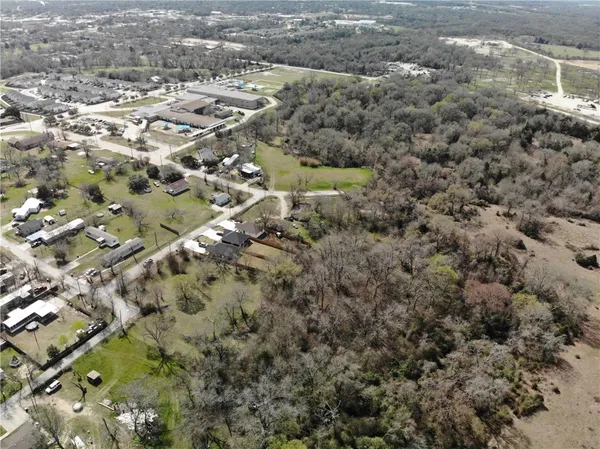 a view of a city with green field