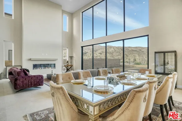 a dining room with furniture a rug and a large window