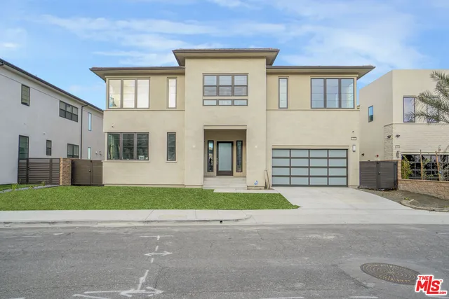 a hallway with a couches and dining table with wooden floor