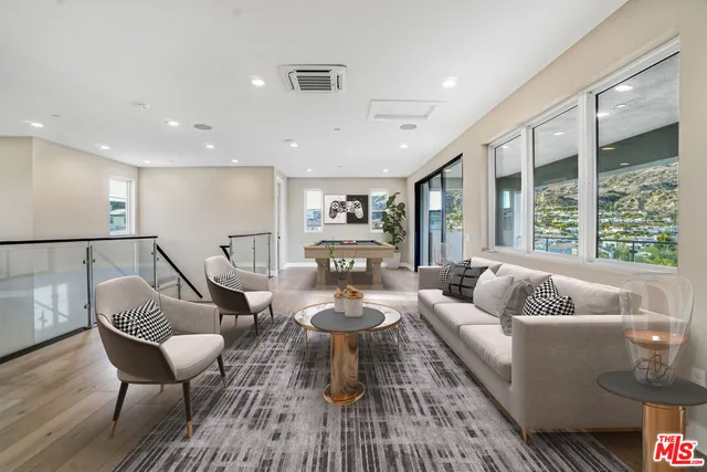 a dining room with furniture water view and a floor to ceiling window