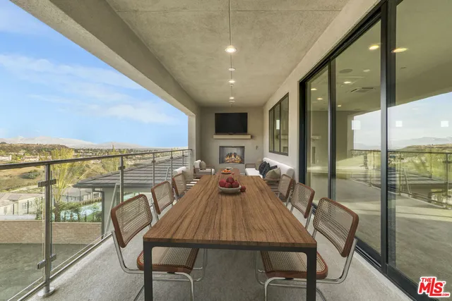 a view of a livingroom with a large window and wooden floor