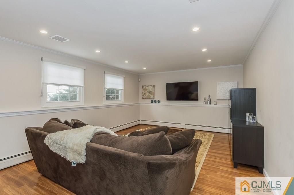 53 Lynnwood Road Edison, NJ 08820 - Photo 15 of 19 a living room with furniture and a flat screen tv