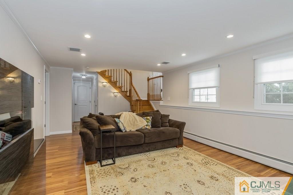 53 Lynnwood Road Edison, NJ 08820 - Photo 16 of 19 a living room with furniture and a flat screen tv