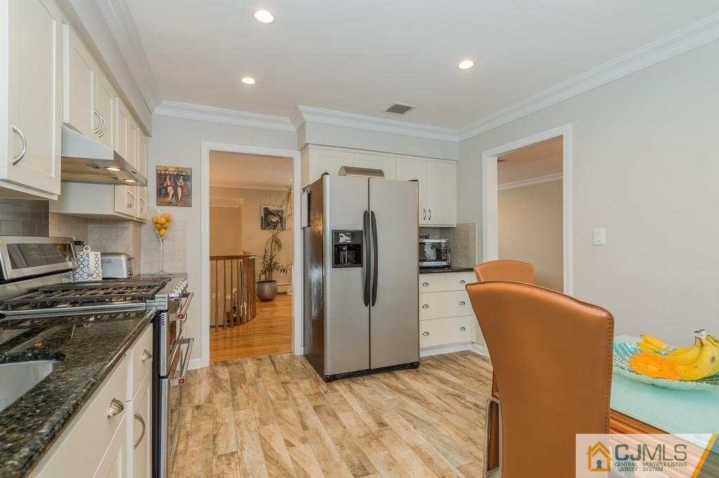 53 Lynnwood Road Edison, NJ 08820 - Photo 6 of 19 a kitchen with stainless steel appliances granite countertop a refrigerator a stove and a sink