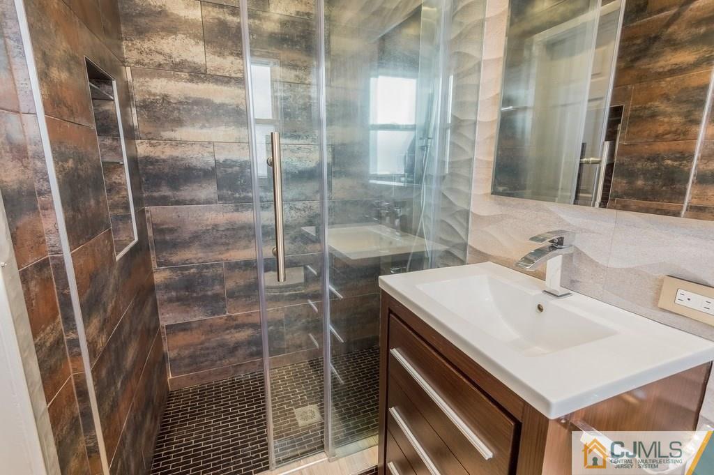 53 Lynnwood Road Edison, NJ 08820 - Photo 10 of 19 a bathroom with a sink a toilet and shower