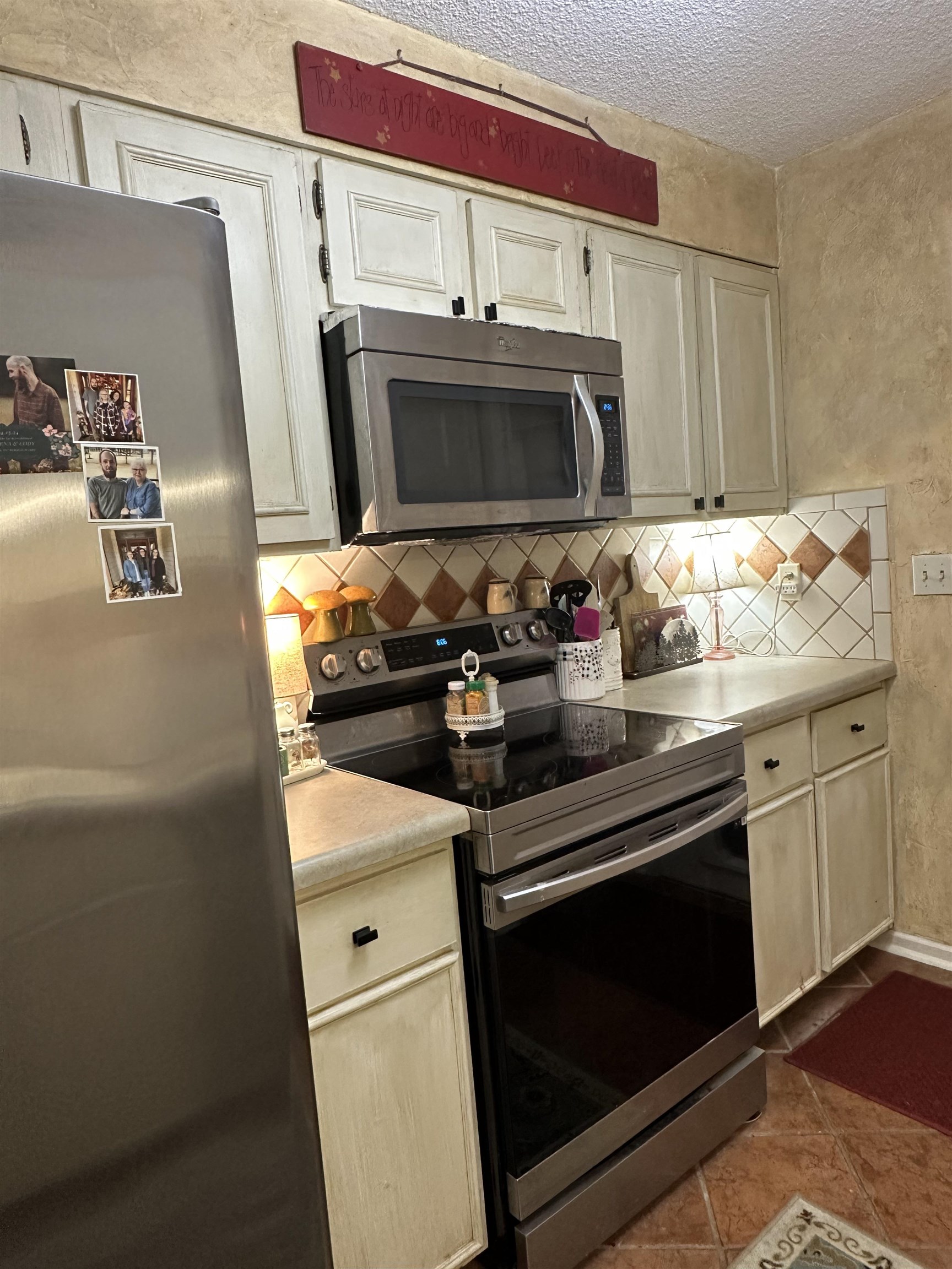 6939 Amberly Road, Unit 6939 Memphis, TN 38119 - Photo 6 of 14 a kitchen with stainless steel appliances a stove a microwave and a sink