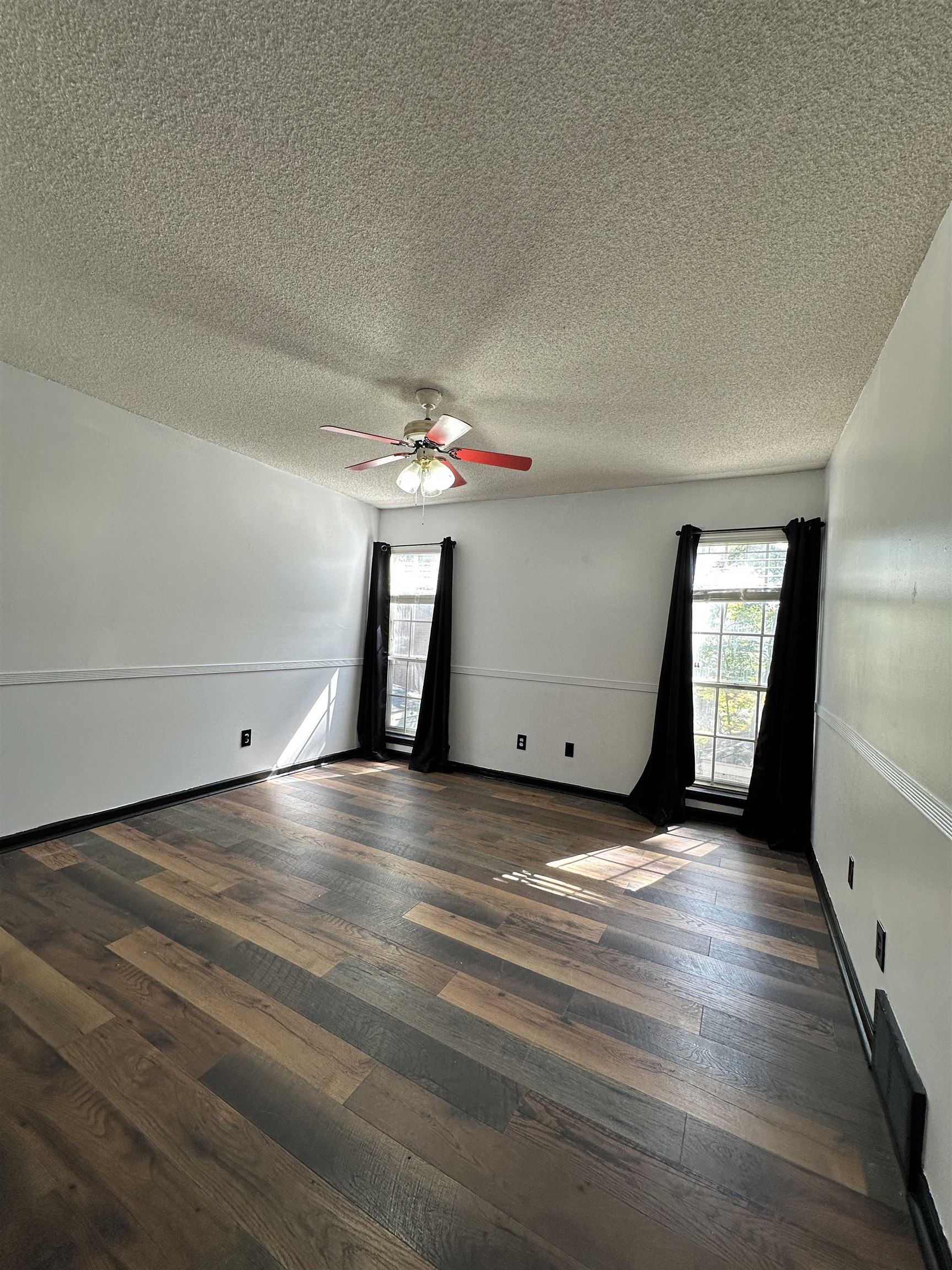 6939 Amberly Road, Unit 6939 Memphis, TN 38119 - Photo 10 of 14 wooden floor in an empty room with a window