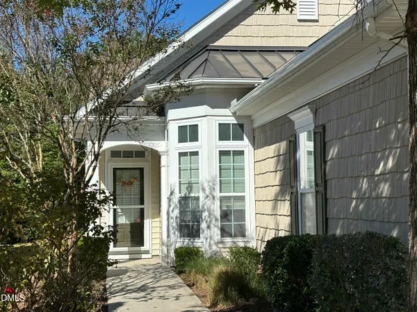 a kitchen with stainless steel appliances granite countertop a refrigerator a stove and a sink with wooden floor