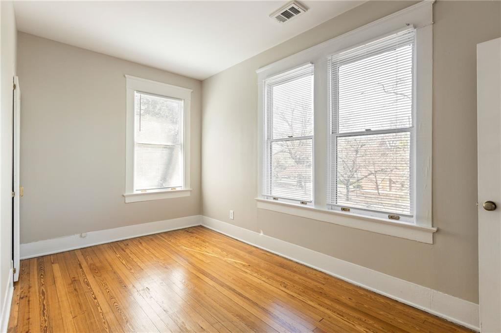 120 South Candler Street Decatur, GA 30030 - Photo 21 of 40 a view of an empty room with wooden floor and a window