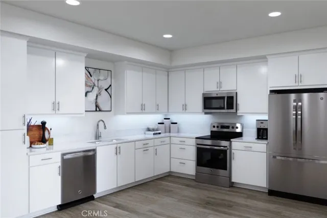 a kitchen with a sink white cabinets and white appliances