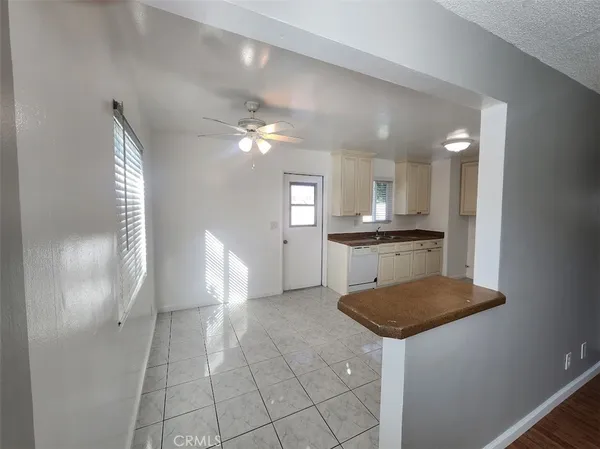 a kitchen with granite countertop a sink cabinets and stainless steel appliances