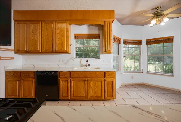 a kitchen with stainless steel appliances granite countertop a stove a sink and a granite counter tops