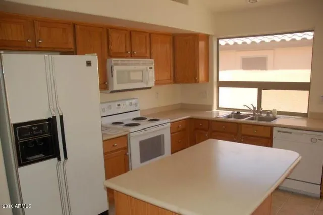 a kitchen with a refrigerator stove and sink