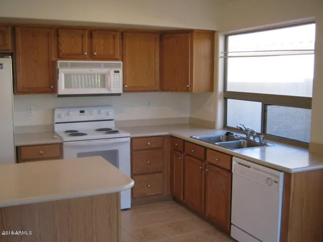 a kitchen with a sink and a stove top oven